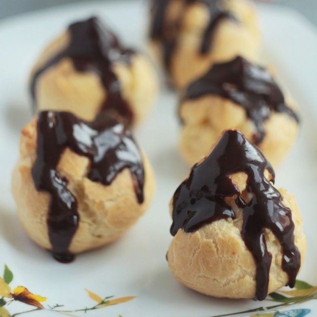 Chocolate dipped profiteroles filled with vanilla custard